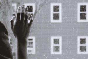 hand on the window depicting depression
