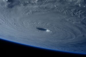 A satellite view of Hurricane at peak intensity, showing a well-defined eye surrounded by spiraling bands of deep convection over the open Atlantic Ocean.